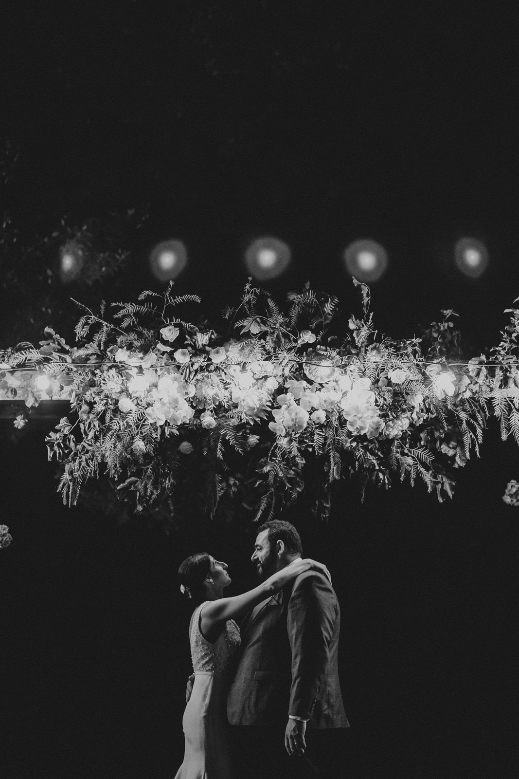 Romantic and emotional wedding photos - couple under flowers in nighttime at Flowerdale Estate